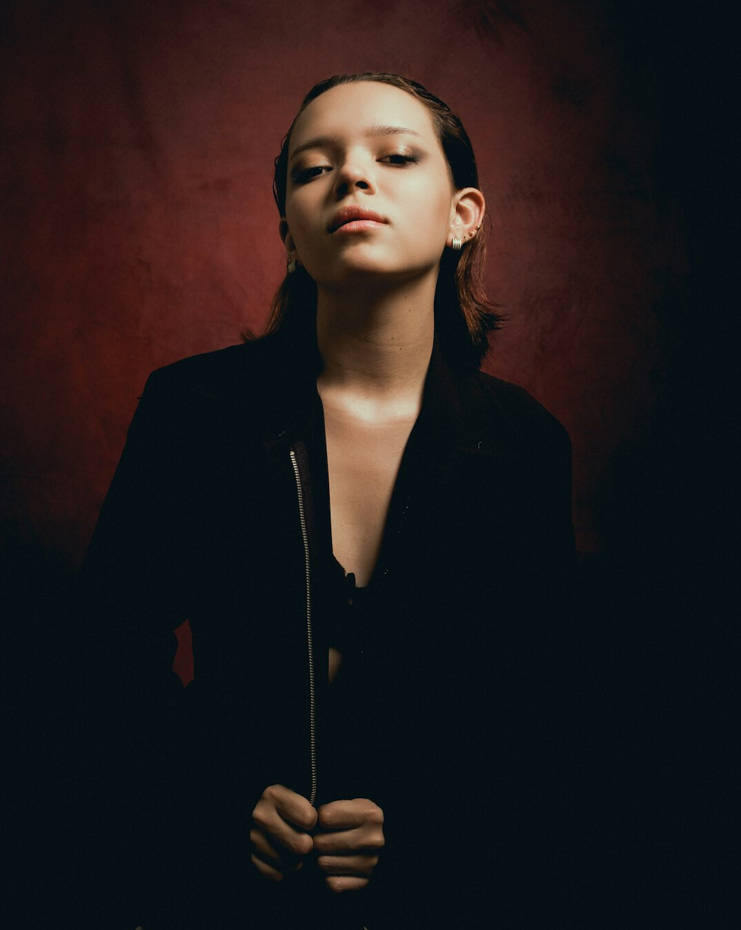 Studio portrait of a smiling woman in a dark blazer